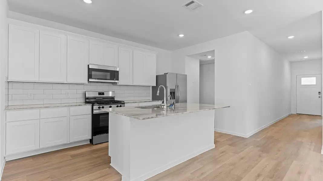 Furnished interior view inside a new home in Caldwell Crossing, Iowa Colony (Image 3).