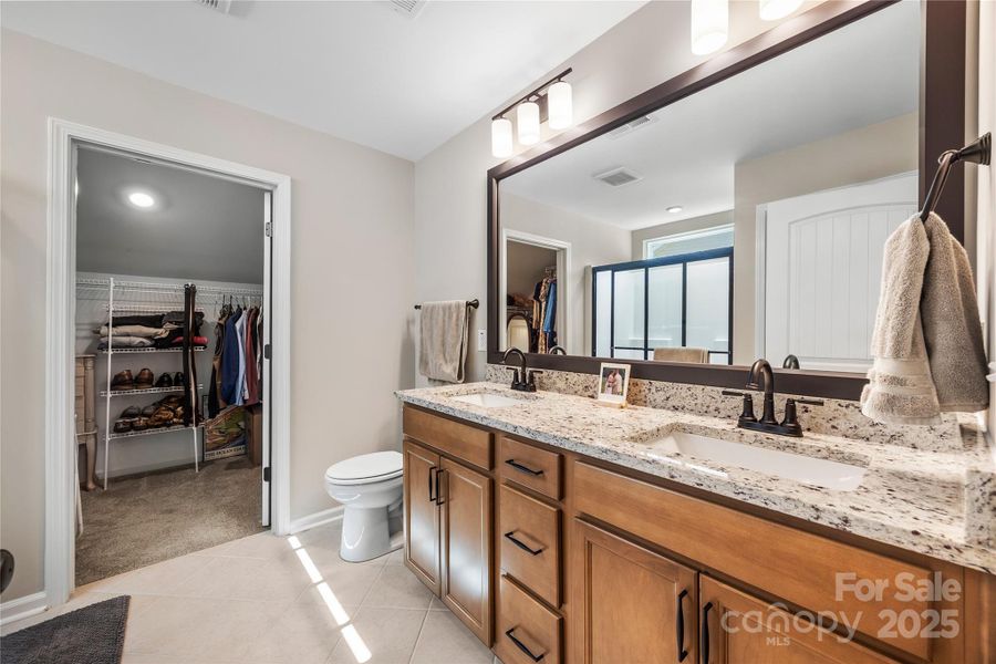 Primary bath features dual vanity sinks, walk-in shower and a large walk-in closet. Primary bath features dual vanity sinks, walk-in shower and a large walk-in closet.