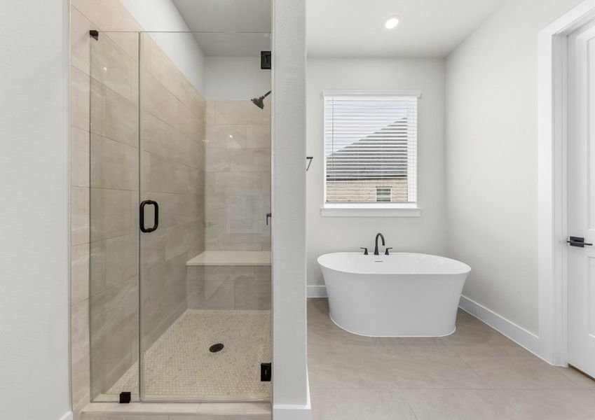 The master bathroom has a glass, walk-in shower and garden tub.
