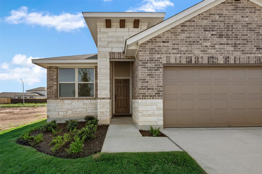 Front exterior of a new home in Rolling Glen, Hutto, TX, highlighting curb appeal (Image 22). Front exterior of a new home in Rolling Glen, Hutto, TX, highlighting curb appeal (Image 22).