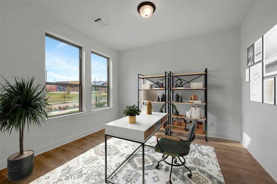 Office area with light wood-type flooring and baseboards
