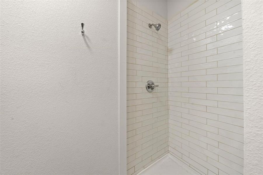 Bathroom with a shower stall Bathroom with a shower stall
