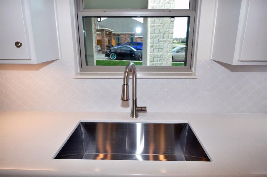 Undercounted Single bowl stainless sink.