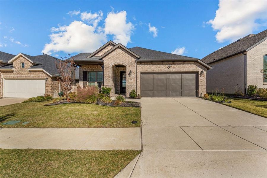 View of front of house featuring a front yard and a garage