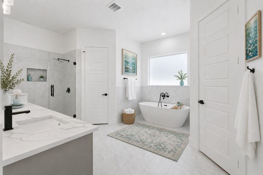 Beautiful master en suite spa bathroom with soaking tub, dual vanities, separate shower, his and hers walk-in closets, privacy glass (let's light in but without sacrificing your privacy), beautiful tile floors, pristine. Beautiful master en suite spa bathroom with soaking tub, dual vanities, separate shower, his and hers walk-in closets, privacy glass (let's light in but without sacrificing your privacy), beautiful tile floors, pristine.
