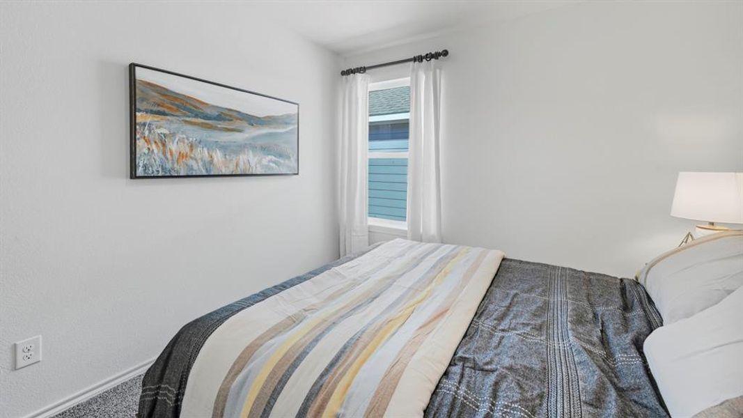 Bedroom featuring baseboards and carpet floors