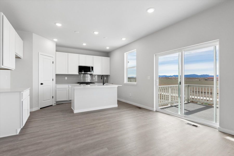 A kitchen with a large glass door. A kitchen with a large glass door.
