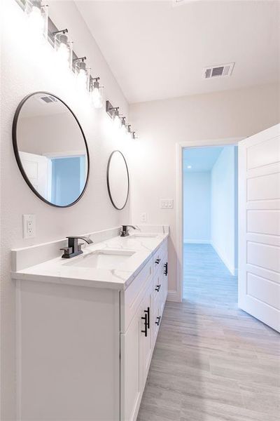 Bathroom featuring dual bowl vanity