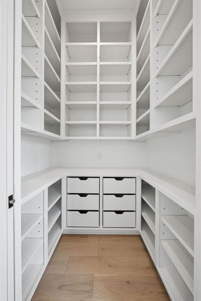 Custom-designed walk-in pantry. Functioning as a high-end butler’s station, this space seamlessly extends the home's gourmet capabilities with premium finishes and thoughtful utility.