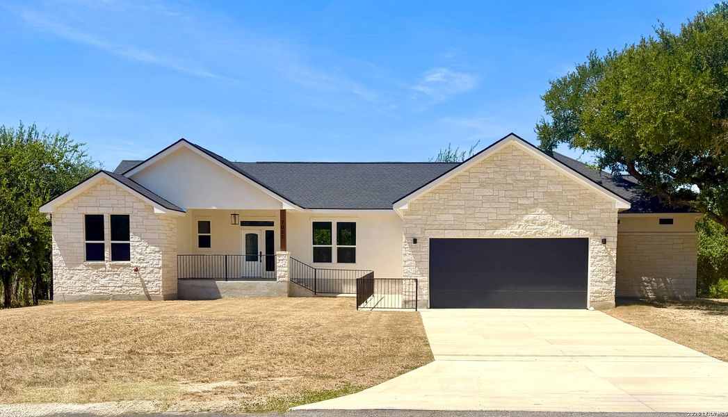 Front exterior of a new home in , Bulverde, TX, highlighting curb appeal (Image 26).