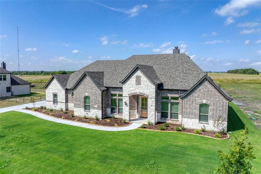 Front exterior of a new home in Pioneer Estates, Blue Ridge, TX, highlighting curb appeal (Image 19). Front exterior of a new home in Pioneer Estates, Blue Ridge, TX, highlighting curb appeal (Image 19).