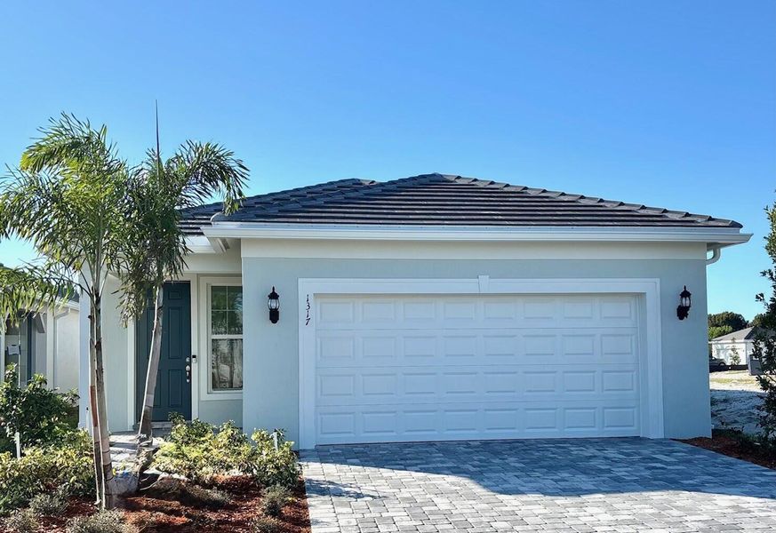 Front exterior of a new home in Costa Pointe, Vero Beach, FL, highlighting curb appeal (Image 1). Front exterior of a new home in Costa Pointe, Vero Beach, FL, highlighting curb appeal (Image 1).
