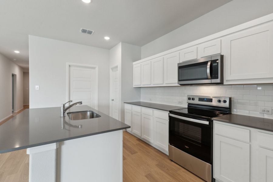 Kitchen in the Hayden home plan by Trophy Signature Homes – REPRESENTATIVE PHOTO