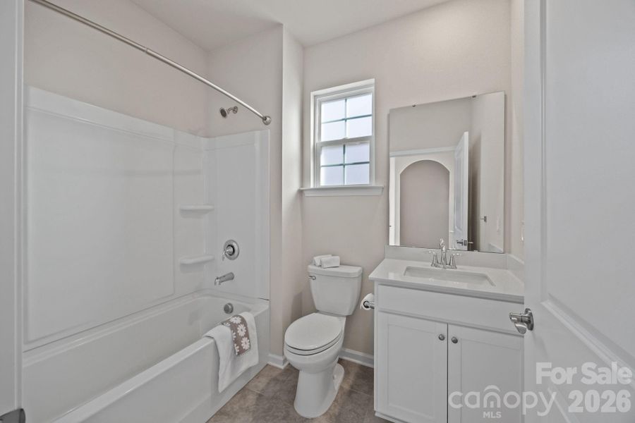 Light-filled Full Bath has arched doorway offset entry for privacy and is located next to Office/Bedroom#1