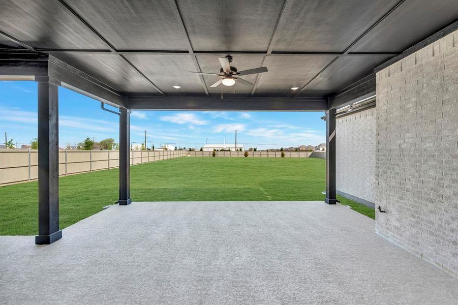 Fenced backyard featuring a ceiling fan and a patio Fenced backyard featuring a ceiling fan and a patio