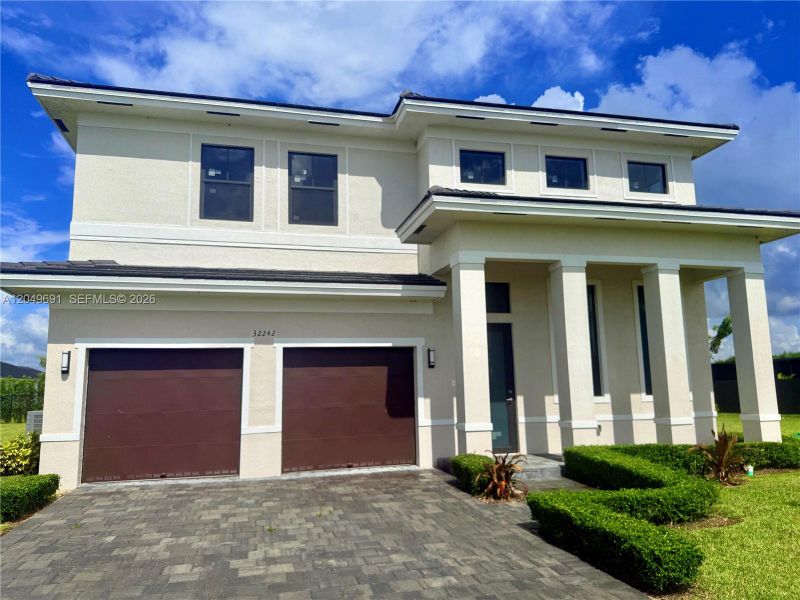 Front exterior of a new home in , Homestead, FL, highlighting curb appeal (Image 21). Front exterior of a new home in , Homestead, FL, highlighting curb appeal (Image 21).