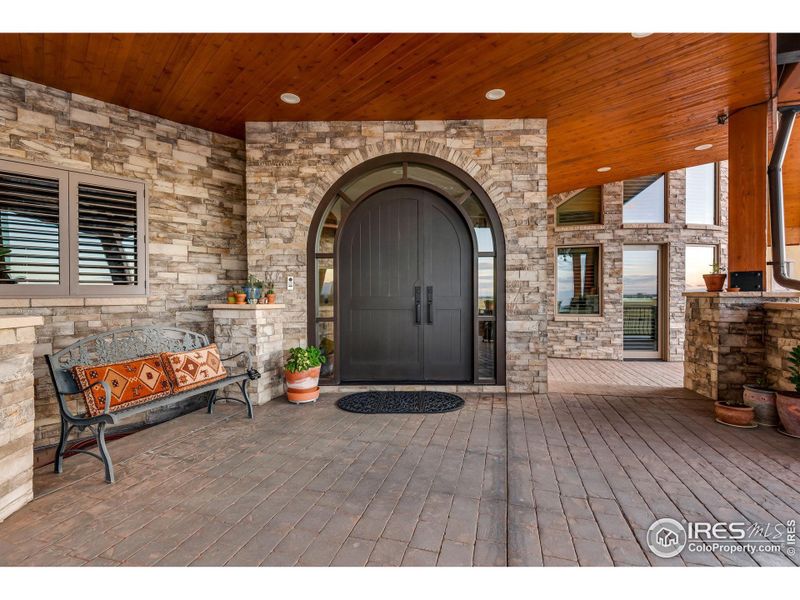 Custom Rift White Oak, 3" Thick Arched, double leaf door with arched insulated glass sidelight with two tune marine grade Italian polyurethane finish system and Black/Brass lockset with deadbolt.