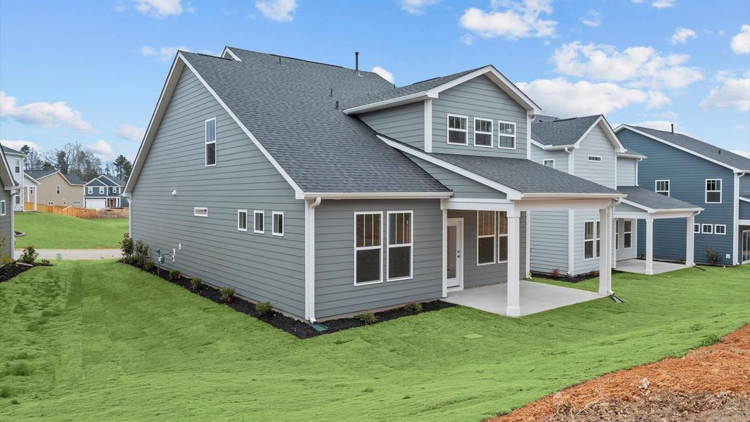 Rear covered porch creates a seamless extension of this home’s elegant design at Pleasant Falls in Moore, SC
