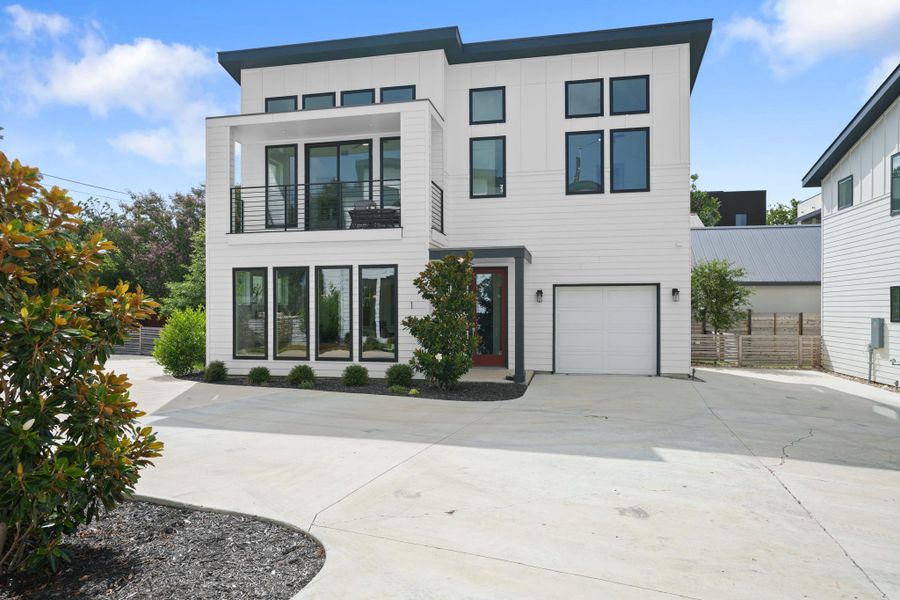 Modern facade with a sleek balcony and large windows offers an inviting exterior. Modern facade with a sleek balcony and large windows offers an inviting exterior.