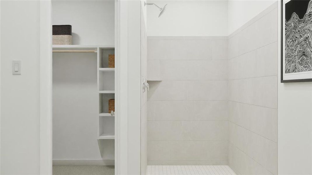 Bathroom with a spacious closet and a stall shower