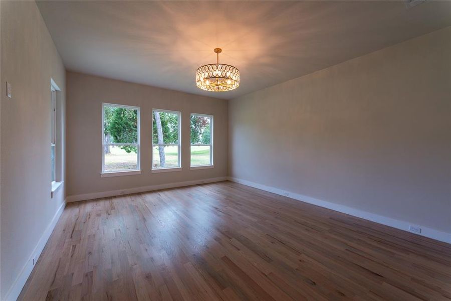 Primary bedroom with view of golf course and pond.