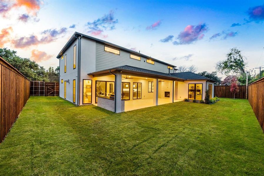 Back of house with a fenced backyard, a patio, and stucco siding Back of house with a fenced backyard, a patio, and stucco siding