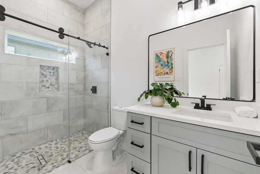 Bathroom 3 featuring vanity, a shower stall, and light tile patterned flooring