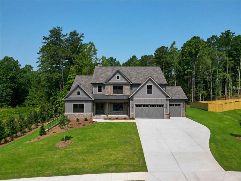 Front exterior of a new home in Spring Creek, Monroe, GA, highlighting curb appeal (Image 1). Front exterior of a new home in Spring Creek, Monroe, GA, highlighting curb appeal (Image 1).