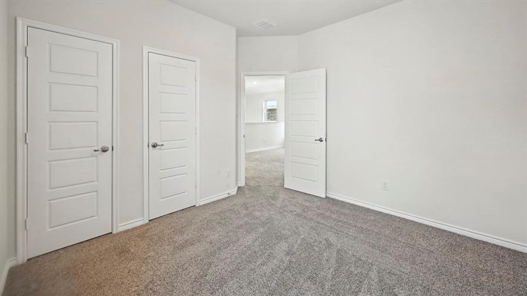 Unfurnished bedroom with carpet and a closet