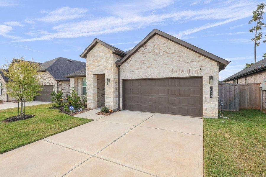 Front exterior of a new home in Hills of Westlake, Conroe, TX, highlighting curb appeal (Image 1).