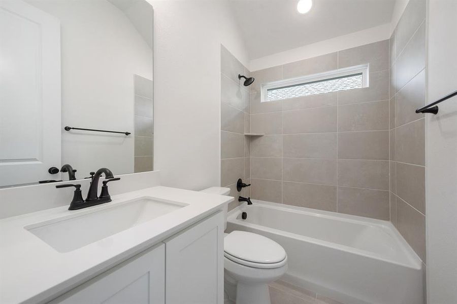 Bathroom featuring tub / shower combination and vanity Bathroom featuring tub / shower combination and vanity