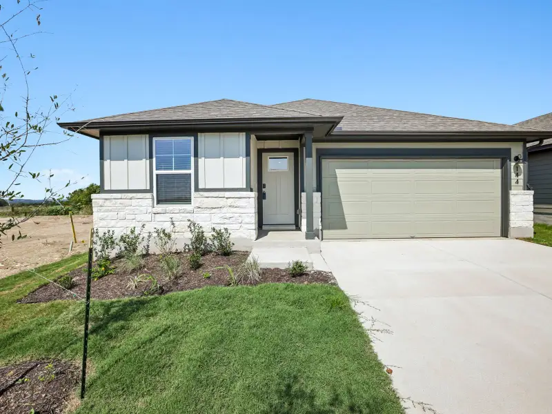 Front exterior of a new home in Travena - Reserve Collection, Georgetown, TX, highlighting curb appeal (Image 1). Front exterior of a new home in Travena - Reserve Collection, Georgetown, TX, highlighting curb appeal (Image 1).