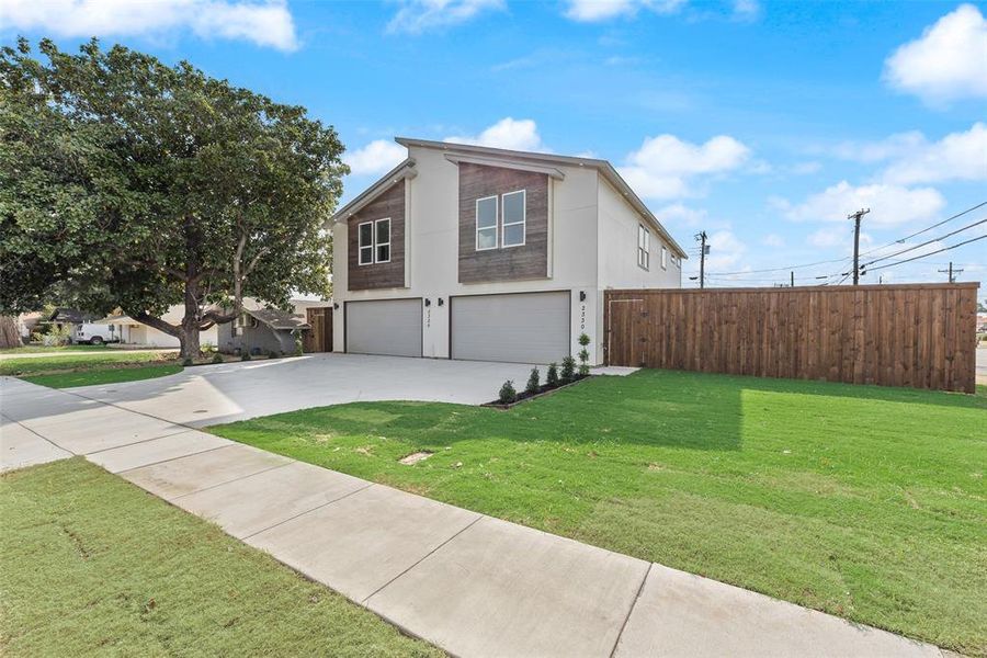 Contemporary house with an attached garage, stucco siding, and driveway