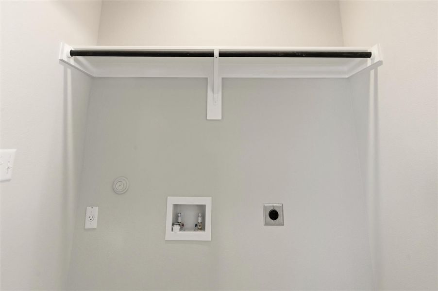 Laundry area with hookup for a washing machine, hookup for an electric dryer, and gas dryer hookup