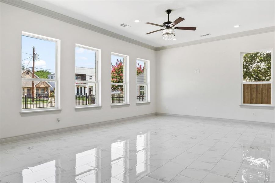 Living room with crown molding, light finish floors, ceiling fan, and recessed lighting Living room with crown molding, light finish floors, ceiling fan, and recessed lighting