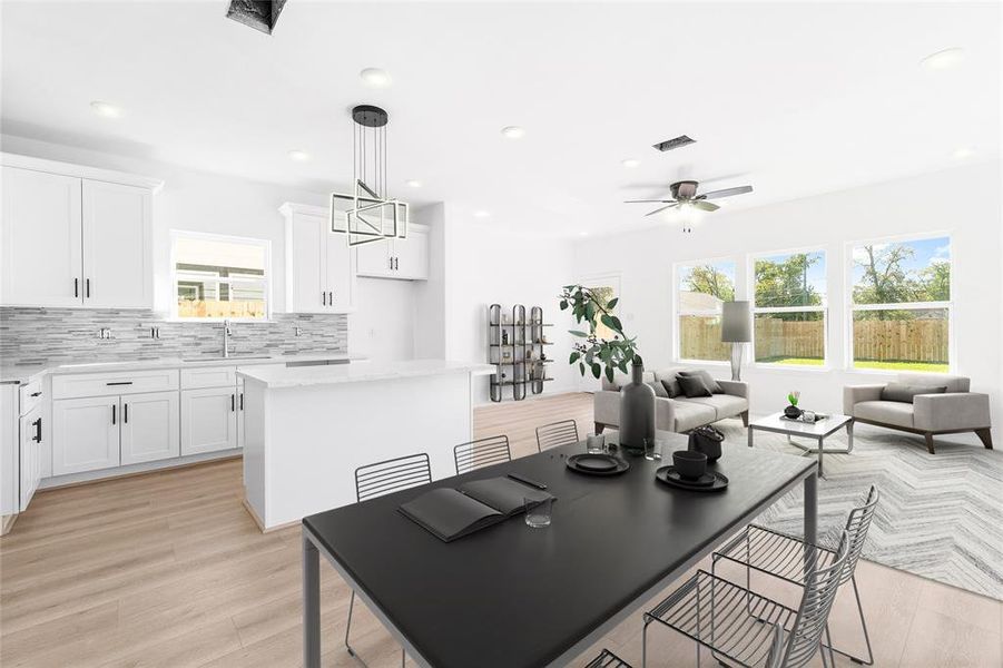 From the dining room, enjoy the seamless flow of this open-concept space, with the kitchen to your left and the living room just ahead. (Photo may be enhanced and may include virtual staging)