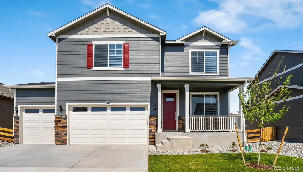 Front exterior of a new home in Brighton Crossing, Brighton, CO, highlighting curb appeal (Image 1).
