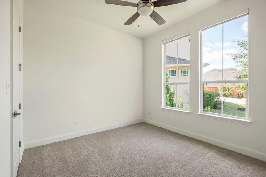 guest room with light carpet and a ceiling fan guest room with light carpet and a ceiling fan