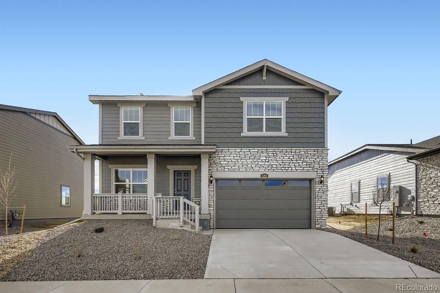 Front exterior of a new home in Ledge Rock, Johnstown, CO, highlighting curb appeal (Image 1). Front exterior of a new home in Ledge Rock, Johnstown, CO, highlighting curb appeal (Image 1).