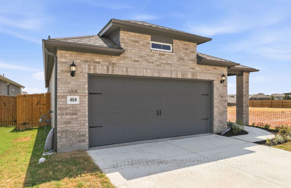 Front exterior of a new home in Crosswinds, Kyle, TX, highlighting curb appeal (Image 2). Front exterior of a new home in Crosswinds, Kyle, TX, highlighting curb appeal (Image 2).