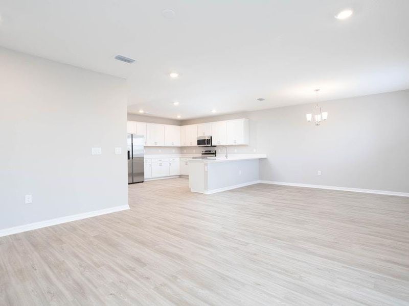 Enjoy an open-concept living area that opens to your patio (or optional lanai) - Wayfair III by Highland Homes Enjoy an open-concept living area that opens to your patio (or optional lanai) - Wayfair III by Highland Homes