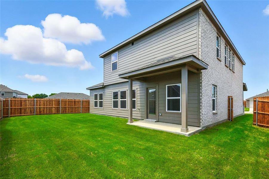 Rear view of house featuring a patio area and a fenced backyard Rear view of house featuring a patio area and a fenced backyard