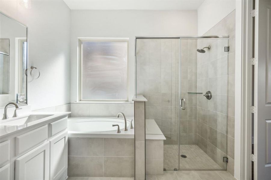 Bathroom with plus walk in shower, vanity, and tile patterned floors