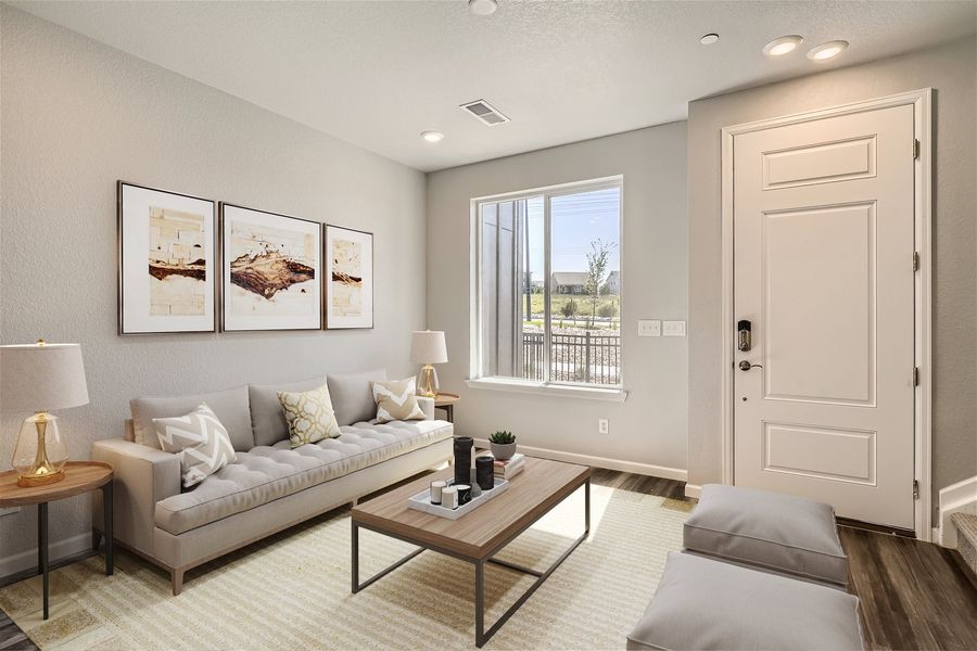 A living room with a couch and a coffee table. A living room with a couch and a coffee table.