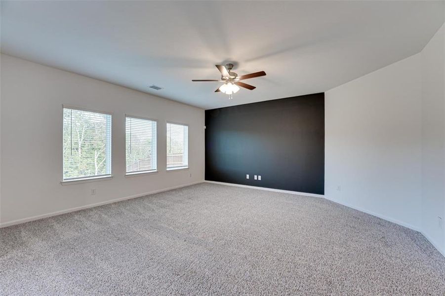 Unfurnished room with ceiling fan and carpet