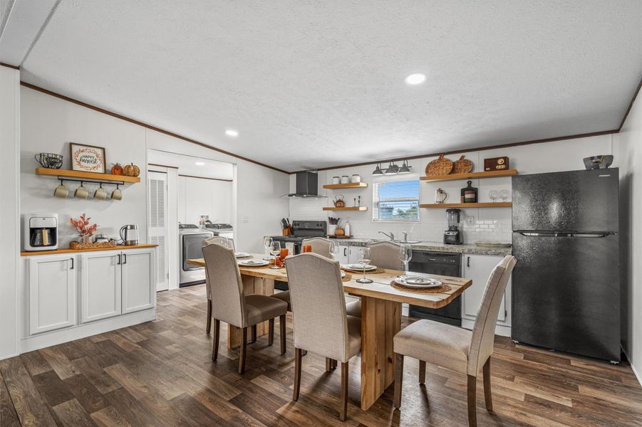 Dining area featuring ornamental molding, recessed lighting, dark wood finished floors, a textured ceiling, and independent washer and dryer
