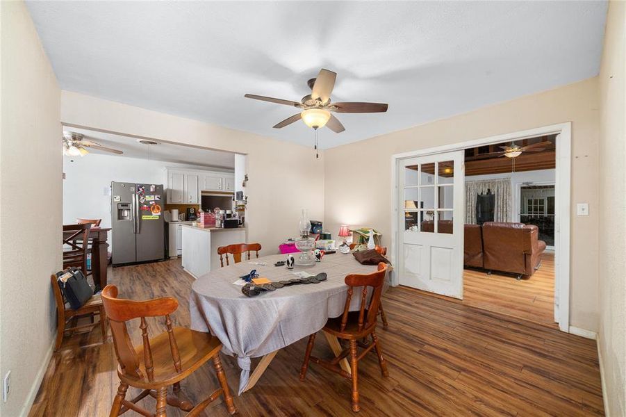 Dining room with ceiling fan and wood-type flooring