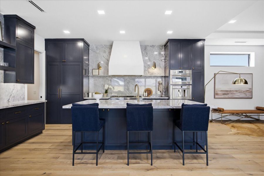 Thoughtfully designed for both beauty and performance, this expansive kitchen blends custom cabinetry, premium finishes, and effortless flow.
