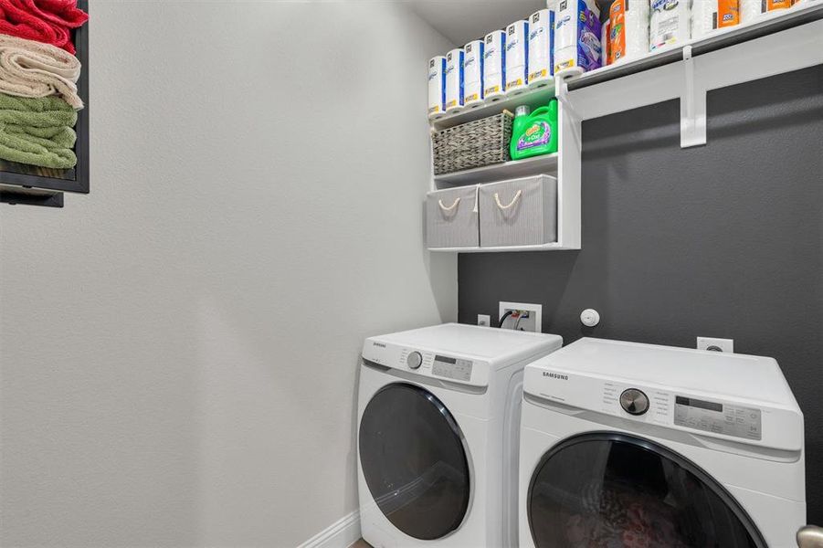 Dedicated laundry area featuring front-loading washer and dryer units
