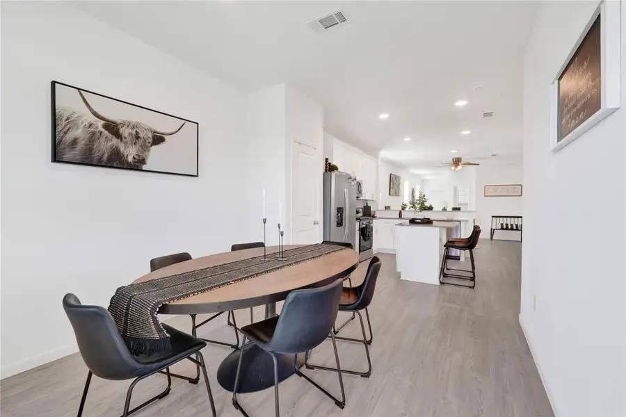 The dining space blends sophistication and warmth, offering an ideal setting for family meals or gatherings with friends—thoughtfully positioned to connect effortlessly with the kitchen and living room.